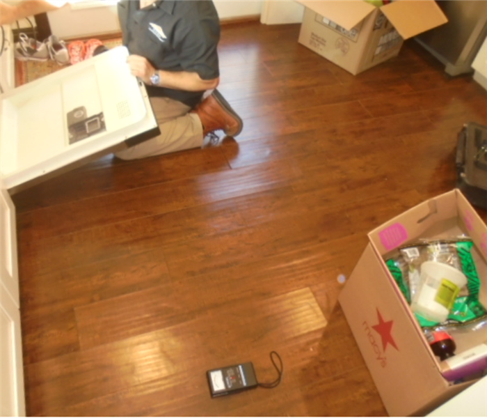 Servpro technician is shown inspecting a room