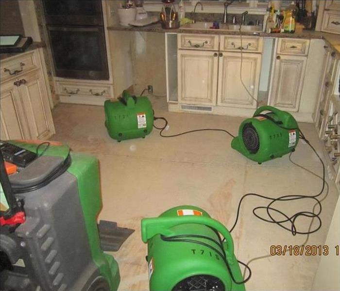 dehumidifier and green air movers in a kitchen, dishwasher removed
