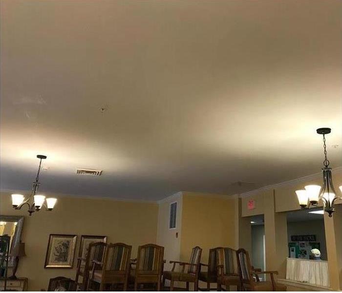 stacked chairs, ceiling stains in a dining area