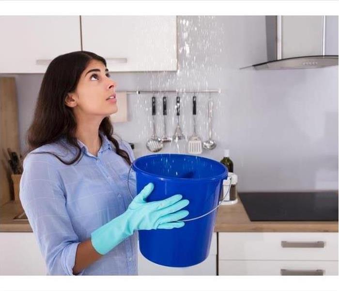 Woman Holding Bucket Under Water Leak