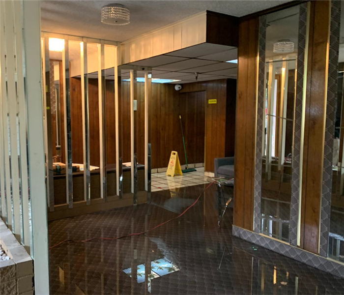 An apartment lobby is shown to be flooded
