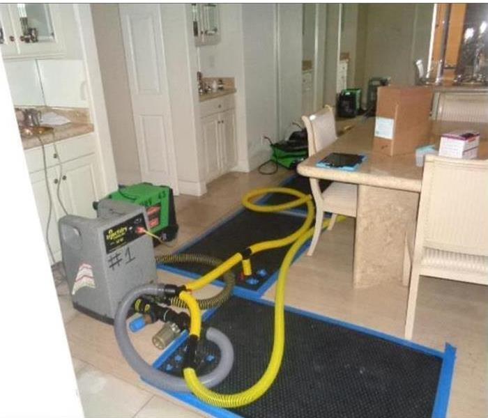 water extraction equipment removing water damage in a kitchen