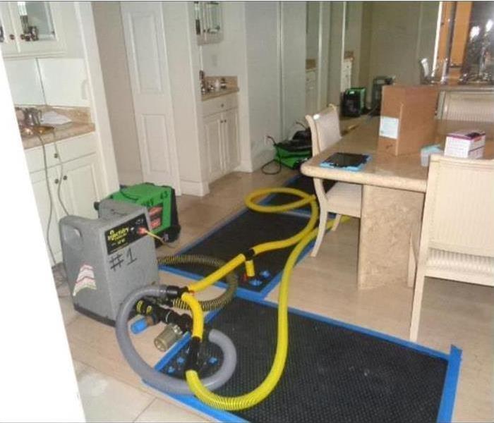 water extraction equipment removing water damage in a kitchen